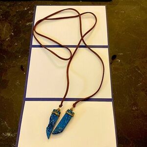 Handmade necklace with brown suede leather and gold wrapped blue stones